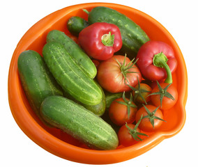 Tomatoes,cucumber and pepper in orange plate