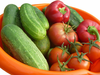 Tomatoes,cucumber and pepper in orange plate