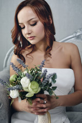 Portrait of the beautiful bride against a window indoors