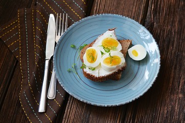 Sandwich with boiled egg and cream cheese for breakfast