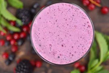 Photo sur Plexiglas Milk-shake Milk shake with berries top view smoothie on a rustic table