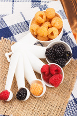 Measuring spoons with different berries inside