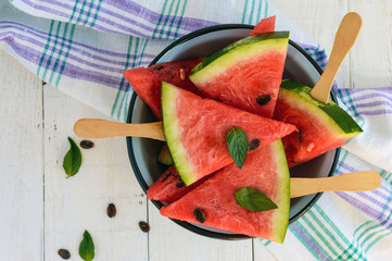 Pieces of ripe watermelon on a stick on a white background. The top view.