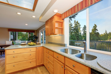 Bright wooden kitchen interior with granite counter tops