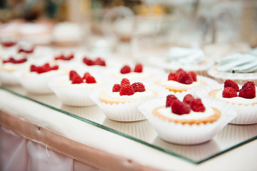 decorated buffet table are cakes and snacks