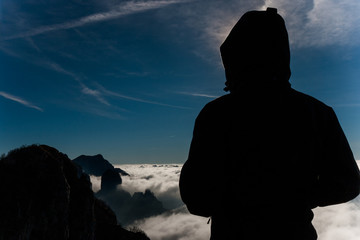Man standing on the top of a mountain.