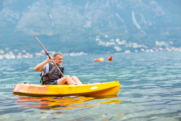 Mature man kayaking on the sea