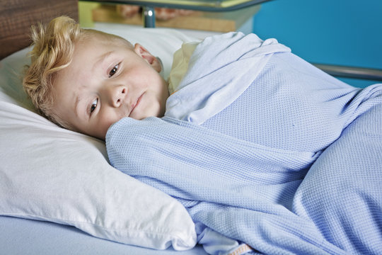 sick little boy in a hospital bed