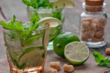 refreshing drink mojitos on wooden table decorated with brown sugar