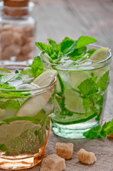 refreshing drink mojitos on wooden table decorated with brown sugar