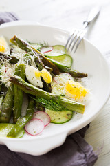 Fresh salad of asparagus, cucumber and boiled eggs with parmesan