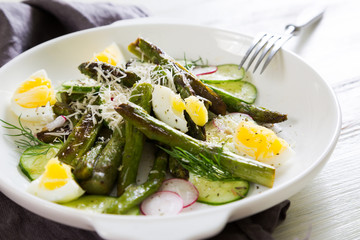 Fresh salad of asparagus, cucumber and boiled eggs with parmesan
