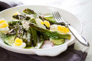 Fresh salad of asparagus, cucumber and boiled eggs with parmesan
