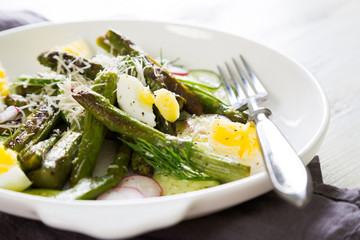 Fresh salad of asparagus, cucumber and boiled eggs with parmesan