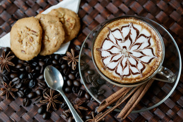 Fototapeta na wymiar A cup of cafe latte with coffee beans and cookies