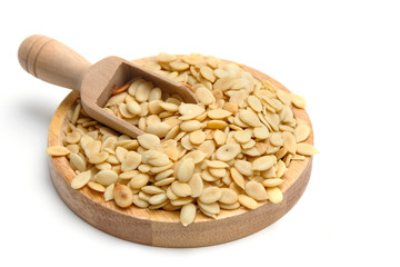 Shelled melon seeds with salt on white background