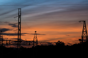 Silhouette of Electric Power Lines and High power transmission line at sunset