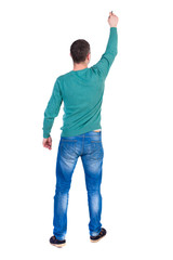 back view of writing business man. Rear view people collection.  backside view of person. Isolated over white background. A man in a green jacket and jeans marker writing on the wall above his head.