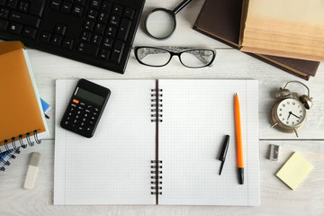 open notebook with pen on wooden background