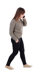 side view of a woman walking with a mobile phone. back view of girl in motion.  backside view of person.  Rear view people collection. Isolated over white background. with his hand in the pocket of a