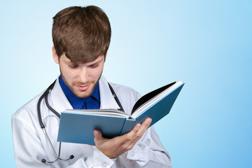 Doctor with stethoscope reading his notes