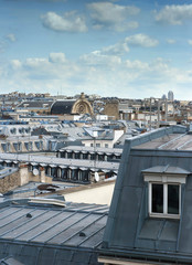 Parisian mansard window and panorama view of Paris rooftops
