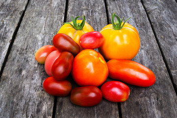 Ecological tomatoes grown by organic farming on a wooden background
