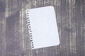 Notebook paper on wood background