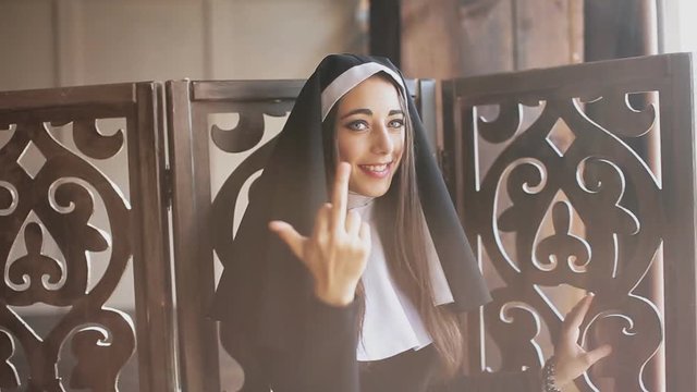 bad nun showing middle finger