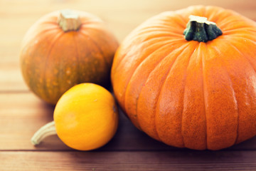 close up of pumpkins on wooden table at home