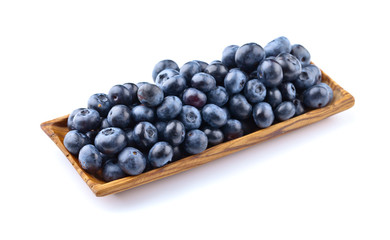 blueberries in wooden dish isolated on white