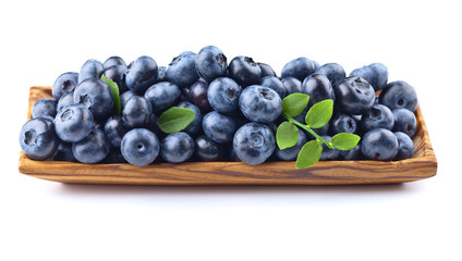 blueberries in wooden dish isolated on white