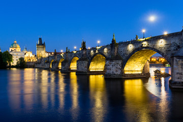 Fototapeta na wymiar The historic center of Prague, ancient architecture and cultural heritage. Charles Bridge at night to the river. Czech Republic