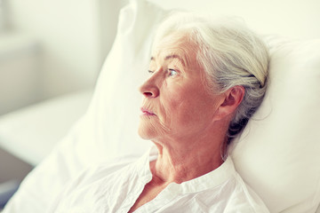 senior woman patient lying in bed at hospital ward
