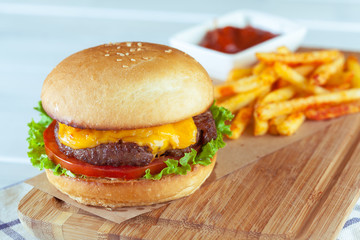burger and french fries on wooden table
