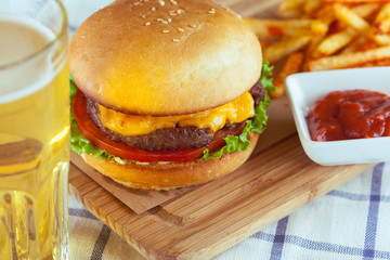 burger and french fries on wooden table