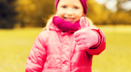 happy girl showing thumbs up outdoors