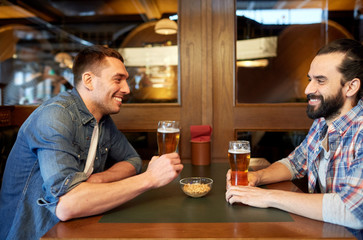 happy male friends drinking beer at bar or pub