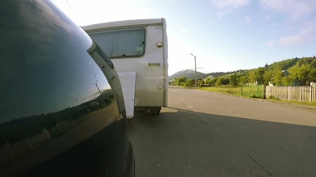 White  caravan ,trailer go  on   road . Life on travel