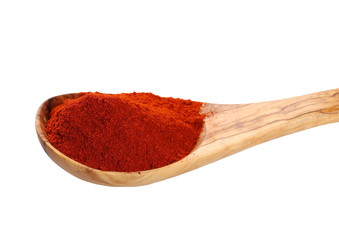  paprika powder and wooden spoon isolated on white, red spices