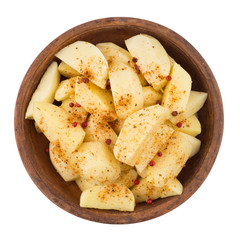 Sliced potatoes in a clay bowl isolated on white background.
