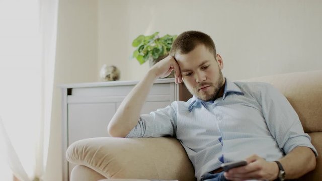 man relaxing with smartphone