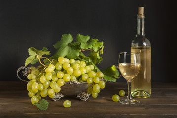 Fototapeta na wymiar White wine, grape on silver basket