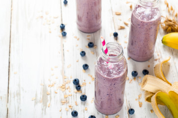 Obraz na płótnie Canvas Blueberry milkshake in the bottles