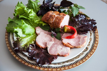Assorted meat with fresh Greens on the table