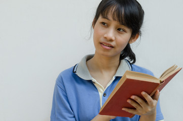 Asian Teenager Girl Thinking When Reading A Book.