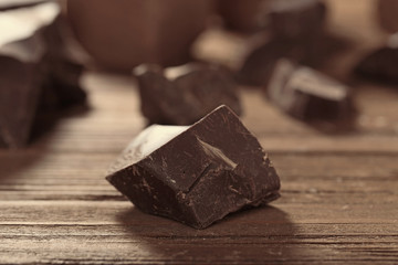 Chocolate chunk on wooden table, closeup
