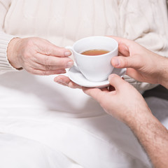Carer helping disabled person