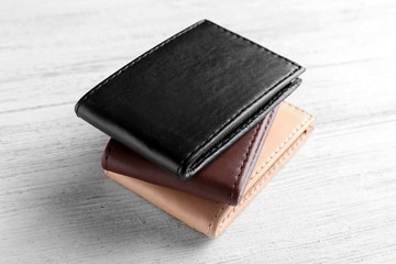 Leather wallets on wooden background