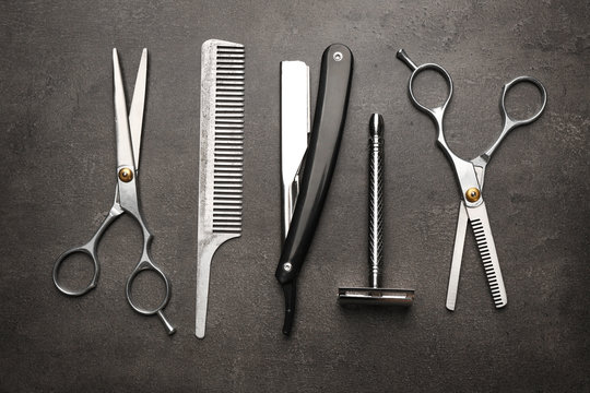 Vintage tools of barber shop on grey background